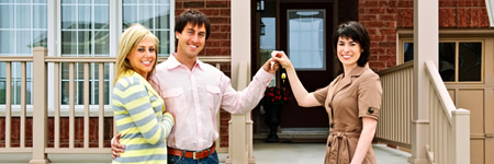 Family outside new home with real estate agent